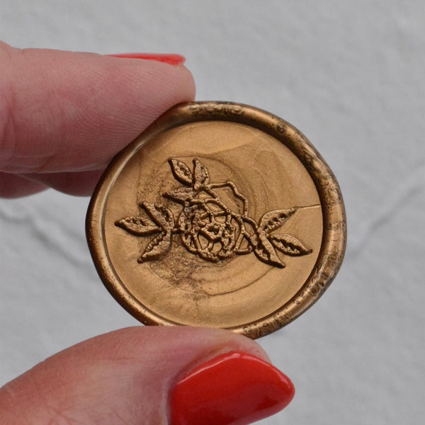 White place card with gold wax seal