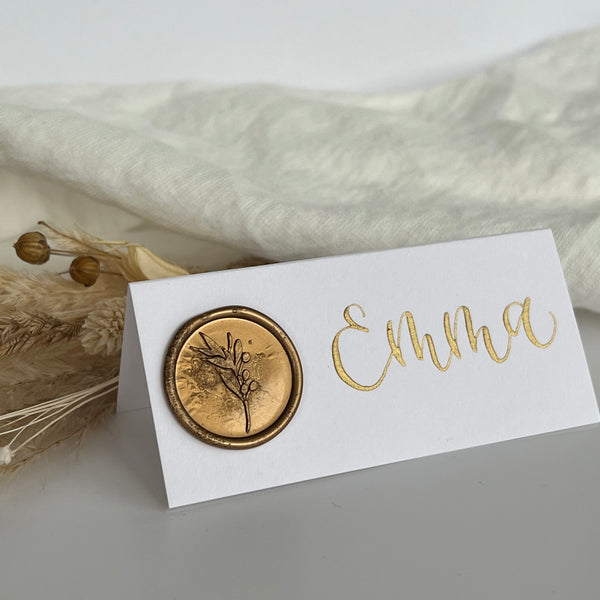 White place card with gold wax seal