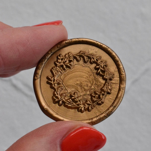 White place card with gold wax seal