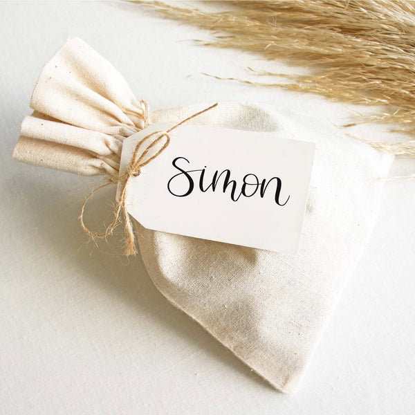 Calligraphy place tag on a linen bag
