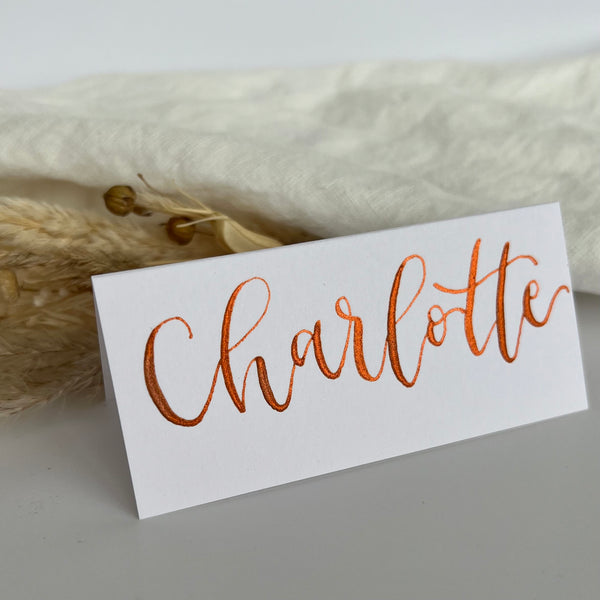 White calligraphy place cards