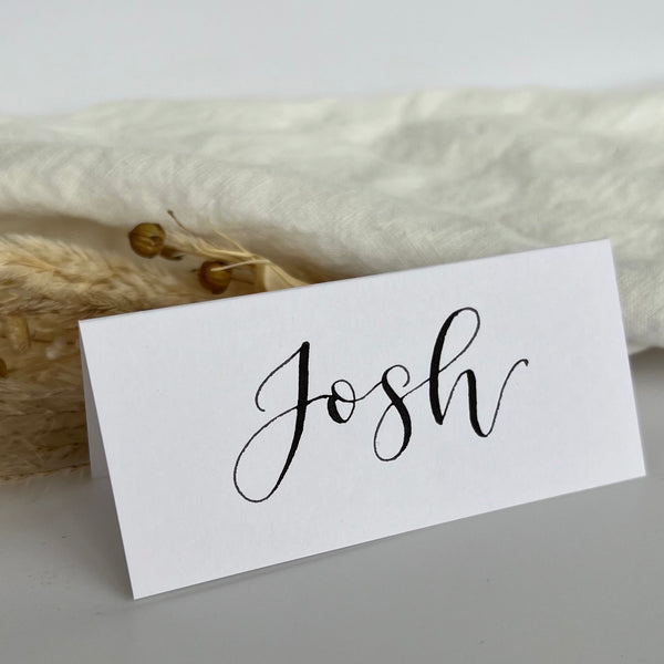 White calligraphy place cards