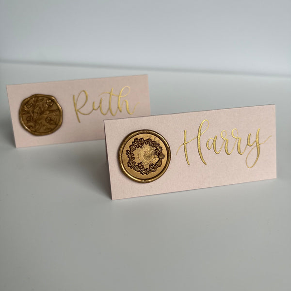 Blush pink place cards with gold wax seal