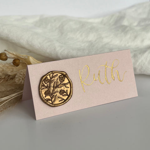 Blush pink place cards with gold wax seal