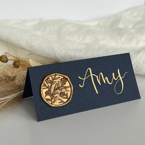Navy place card with gold wax seal