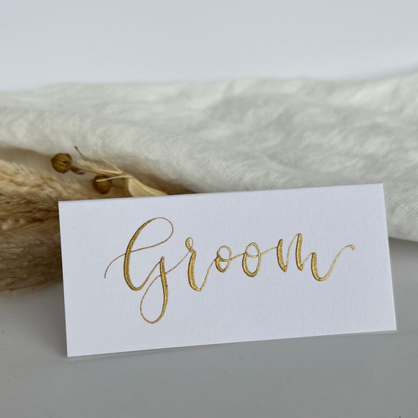 White calligraphy place cards